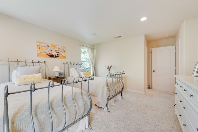 bedroom featuring light carpet