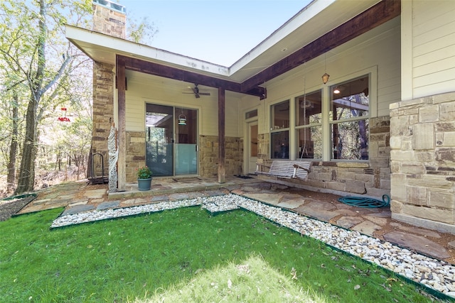 rear view of property with a lawn and ceiling fan