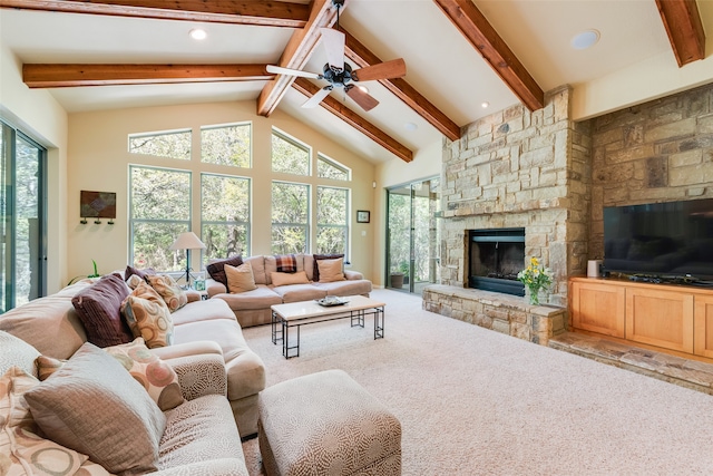 carpeted living room featuring beam ceiling, a stone fireplace, high vaulted ceiling, and ceiling fan