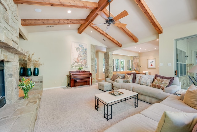 living room featuring a fireplace, light carpet, ceiling fan, beamed ceiling, and high vaulted ceiling