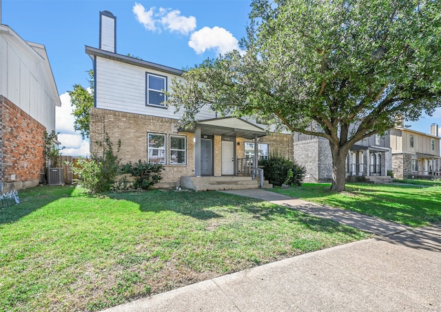 view of front of home with a front lawn and central AC unit