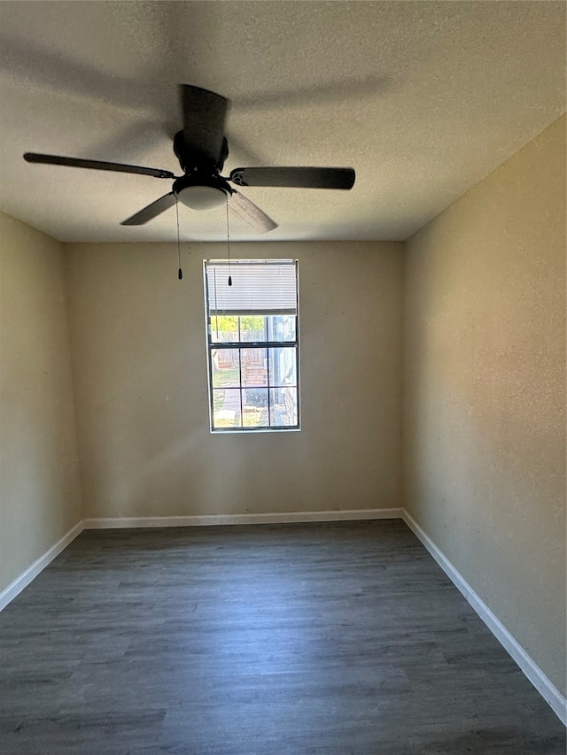 empty room featuring a textured ceiling, dark hardwood / wood-style flooring, and ceiling fan