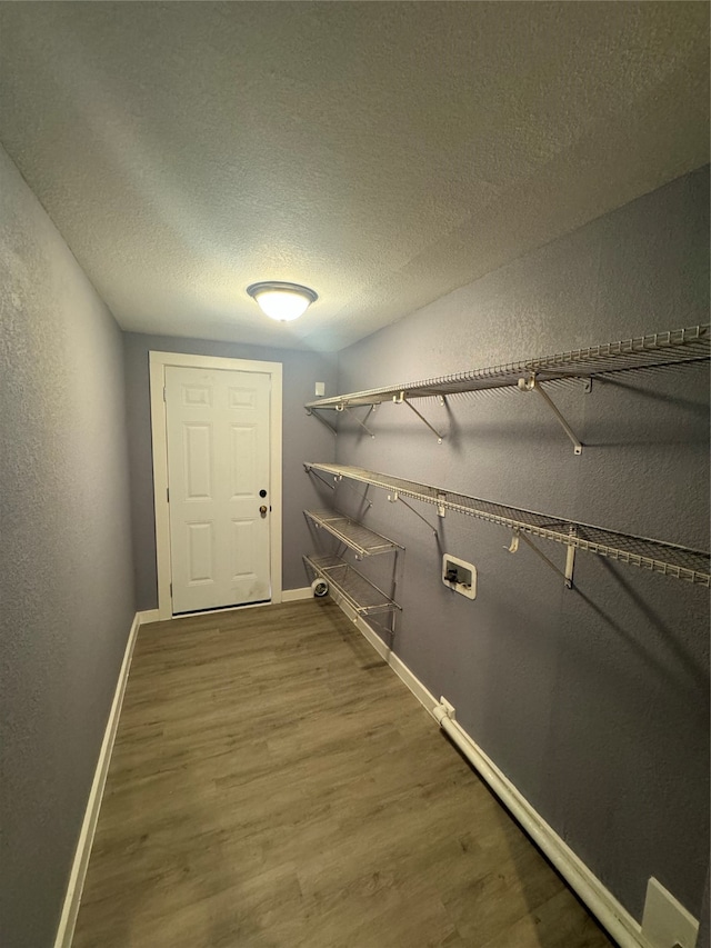 walk in closet with hardwood / wood-style floors