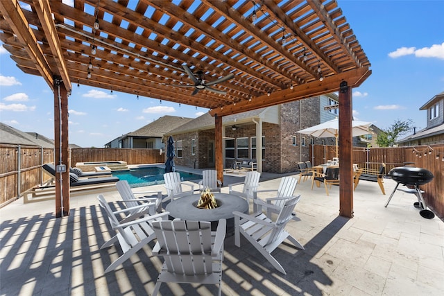 view of patio / terrace featuring grilling area, a pergola, and an in ground hot tub