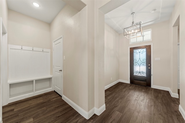 entryway featuring dark wood-type flooring and an inviting chandelier