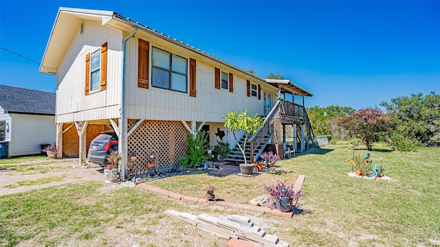 exterior space featuring a carport and a front yard