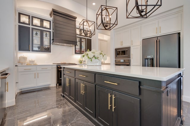 kitchen featuring premium range hood, decorative light fixtures, white cabinetry, a center island, and high quality appliances