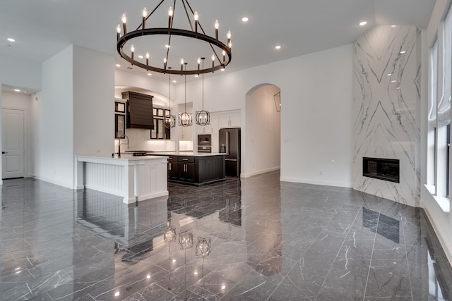 6709 Elderberry Way, Flower Mound, TX 76226 - kitchen featuring high quality fridge, arched walkways, recessed lighting, a chandelier, and light countertops