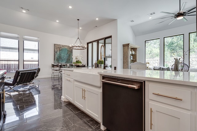 kitchen featuring lofted ceiling, sink, hanging light fixtures, white cabinetry, and dishwasher