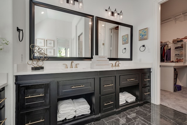 bathroom featuring lofted ceiling and vanity