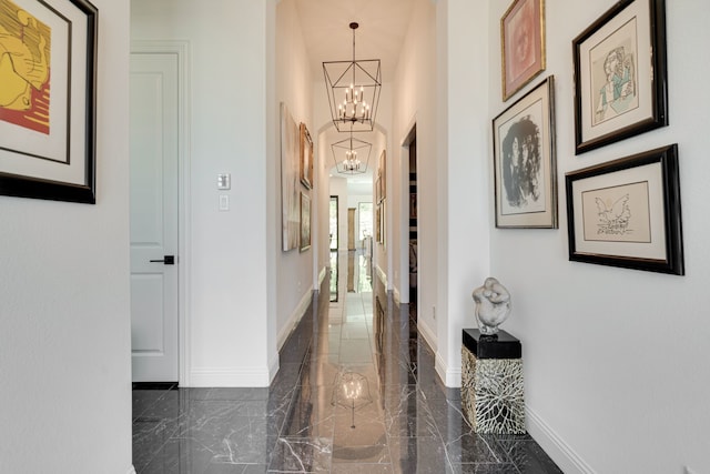 corridor with a notable chandelier