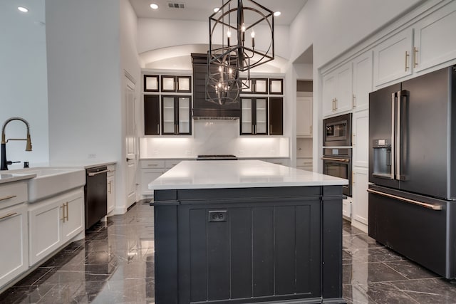 6709 Elderberry Way, Flower Mound, TX 76226 - kitchen with black appliances, dark marble finish floors, a chandelier, a kitchen island, and a high ceiling