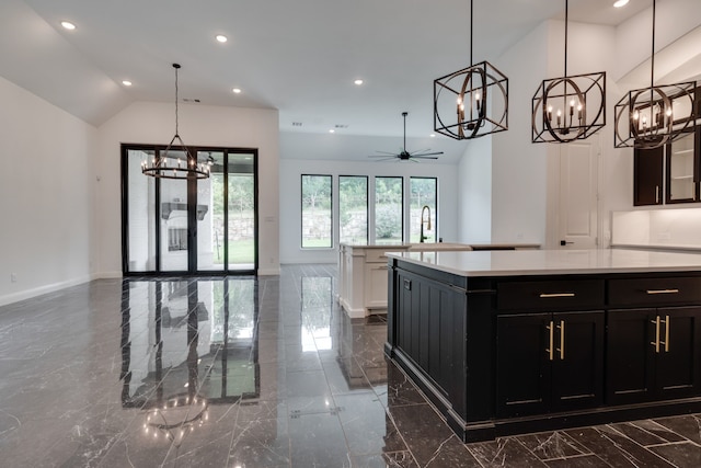 6709 Elderberry Way, Flower Mound, TX 76226 - kitchen with a chandelier, dark marble finish floors, light countertops, dark cabinets, and recessed lighting