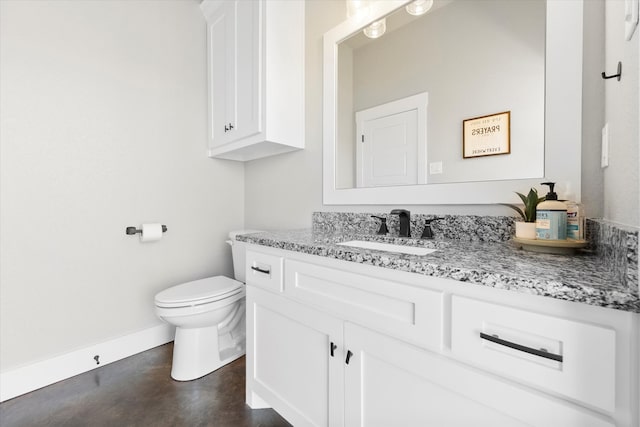 bathroom with toilet, vanity, and concrete flooring