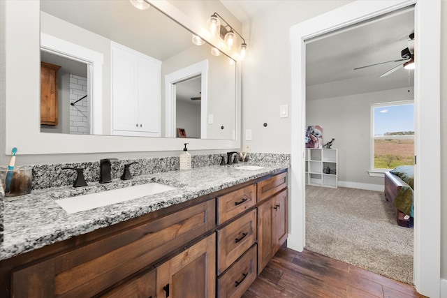 bathroom featuring ceiling fan, wood-type flooring, and vanity