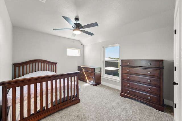 carpeted bedroom with ceiling fan and vaulted ceiling