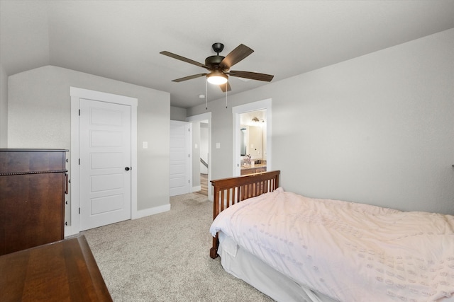 bedroom with ceiling fan, vaulted ceiling, carpet floors, and connected bathroom