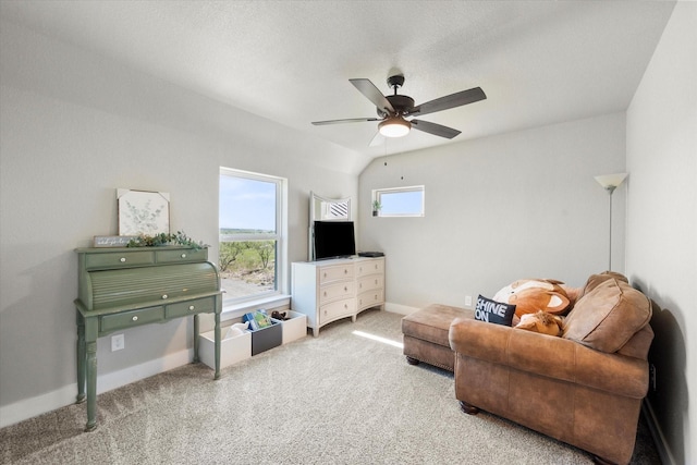 living room with carpet floors, ceiling fan, and lofted ceiling