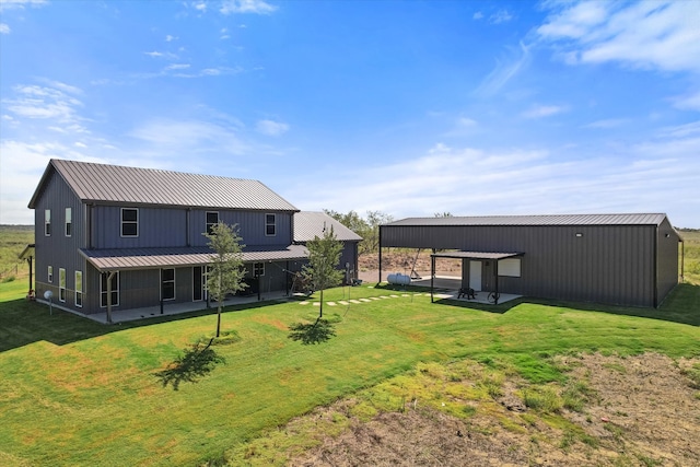 rear view of property featuring a yard