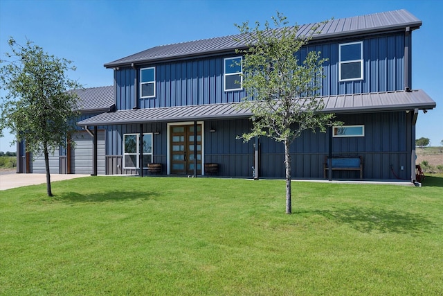 view of front of house featuring a front lawn and a garage