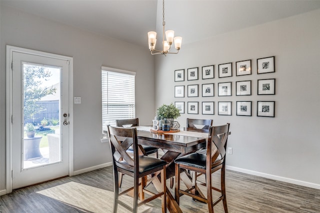 dining room featuring hardwood / wood-style flooring and a chandelier