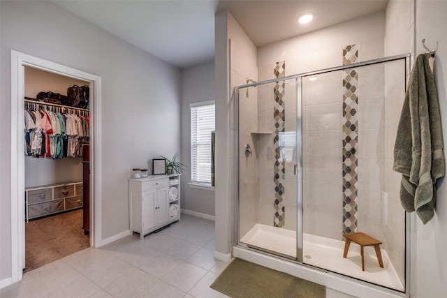 bathroom featuring tile patterned floors and a shower with shower door