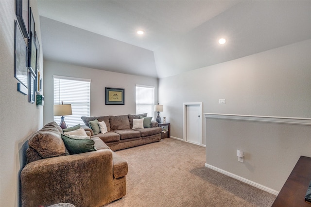 carpeted living room featuring lofted ceiling