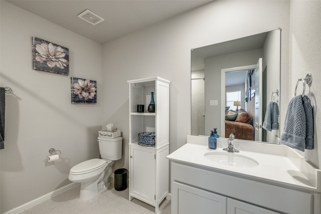 bathroom featuring tile patterned flooring, vanity, and toilet