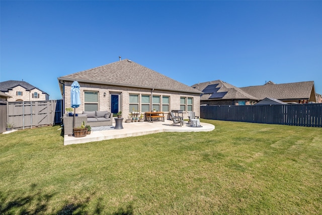 back of property featuring a patio area and a lawn