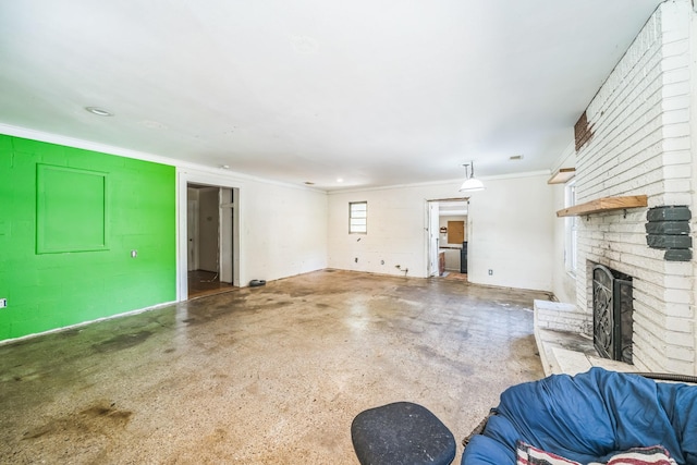 unfurnished living room featuring ornamental molding, a fireplace, and concrete floors