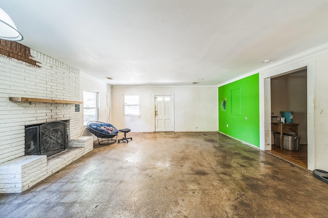 unfurnished living room with crown molding, concrete flooring, and a brick fireplace