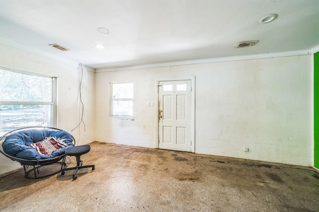 living area with crown molding