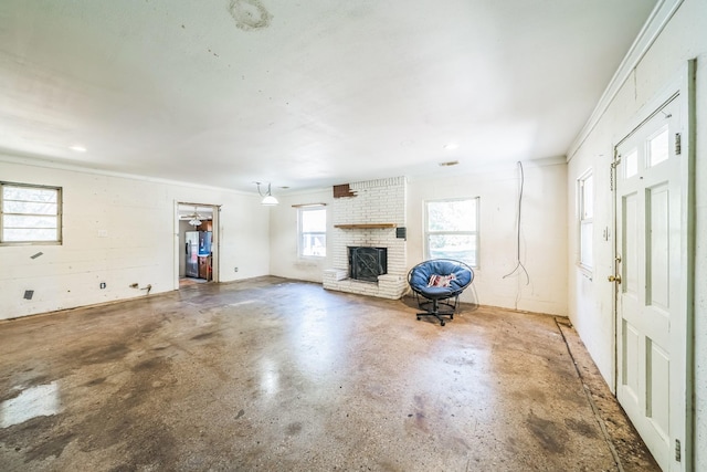 unfurnished living room with concrete floors and a brick fireplace