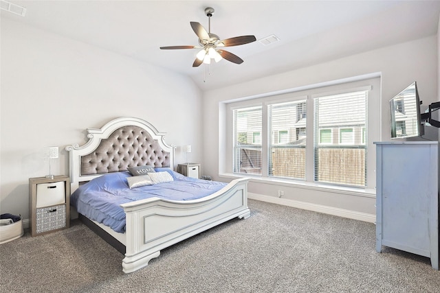 carpeted bedroom featuring lofted ceiling, visible vents, baseboards, and ceiling fan