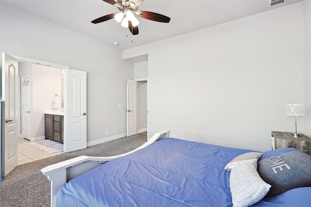 carpeted bedroom featuring ceiling fan and ensuite bathroom