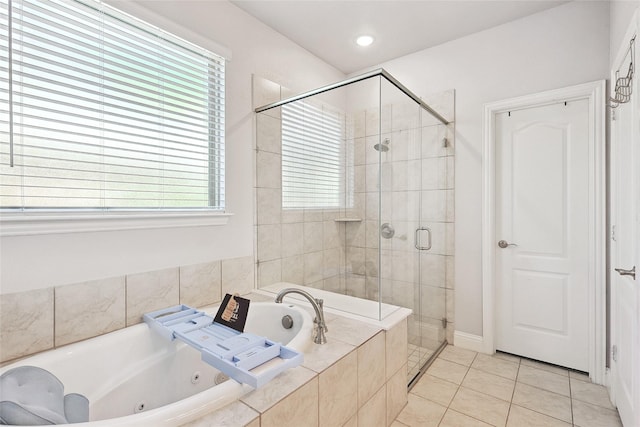 bathroom with a shower stall, tile patterned floors, a tub with jets, and recessed lighting