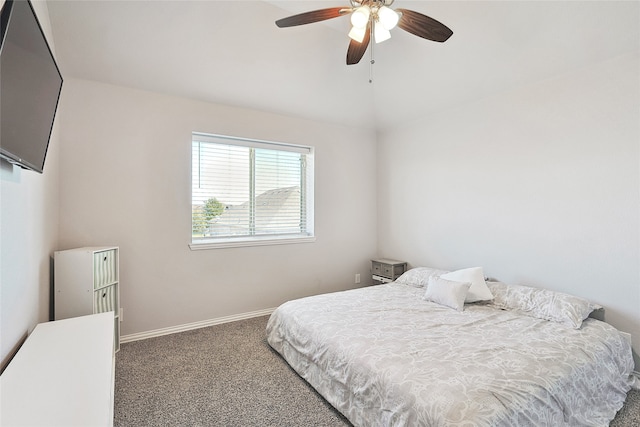 bedroom with ceiling fan and dark colored carpet