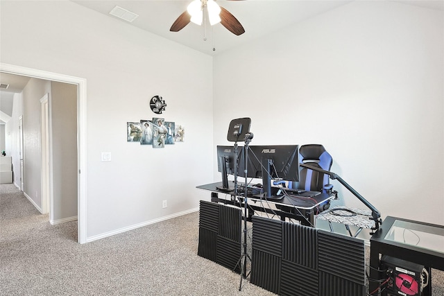 carpeted office featuring visible vents, baseboards, and a ceiling fan