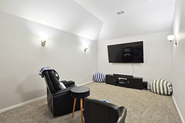 home theater room with lofted ceiling and carpet flooring