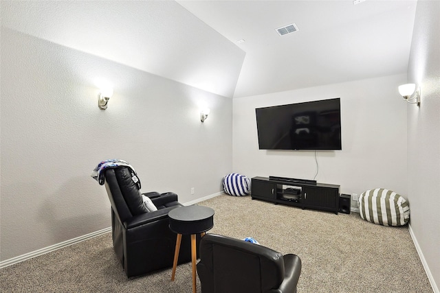 cinema room featuring carpet flooring, visible vents, baseboards, and lofted ceiling