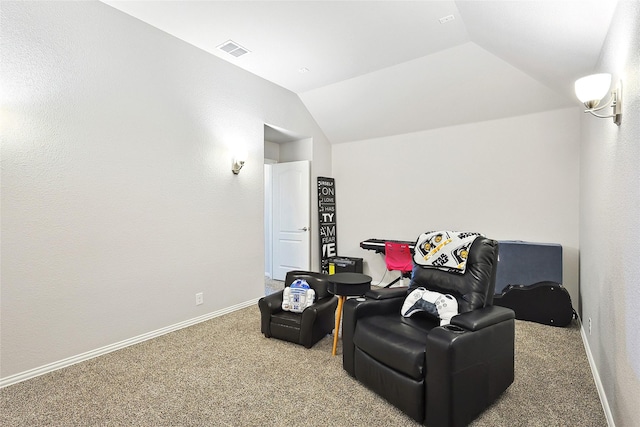 sitting room with baseboards, lofted ceiling, carpet, and visible vents