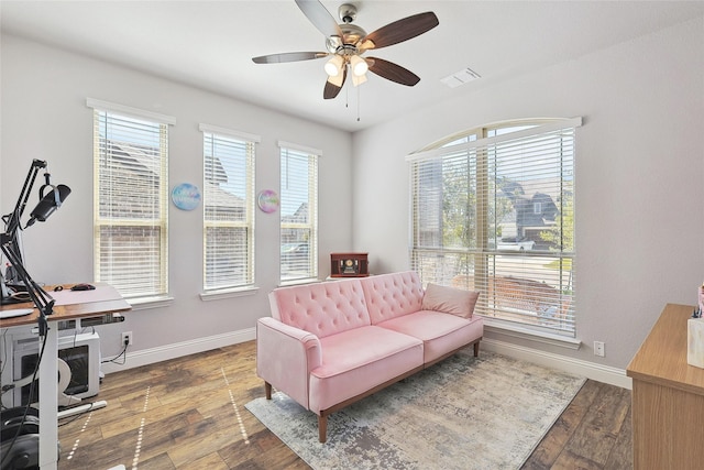 sitting room with visible vents, ceiling fan, wood-type flooring, and baseboards