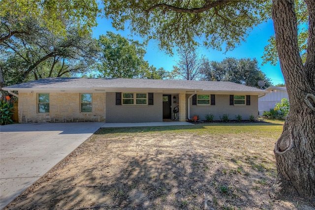 single story home with brick siding and a front lawn