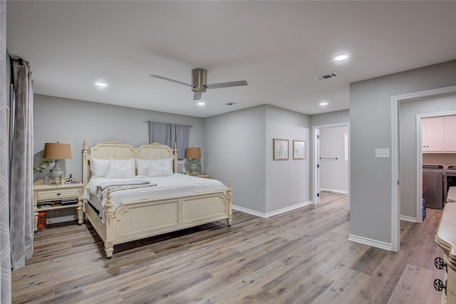 bedroom featuring washer and clothes dryer, ceiling fan, and light hardwood / wood-style flooring