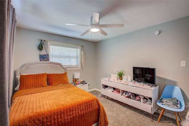 bedroom with carpet, ceiling fan, and a textured ceiling