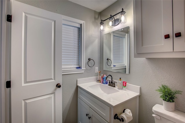 bathroom with vanity and toilet