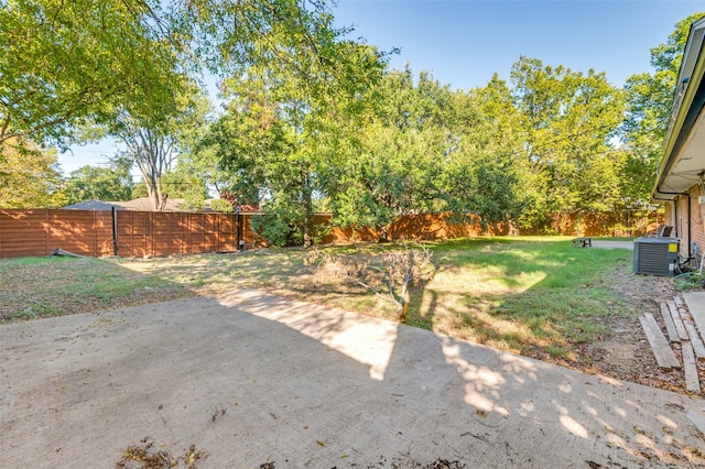 view of yard with central AC unit and a patio