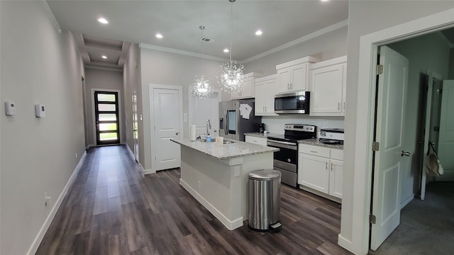 kitchen featuring an island with sink, white cabinetry, hanging light fixtures, appliances with stainless steel finishes, and dark hardwood / wood-style flooring