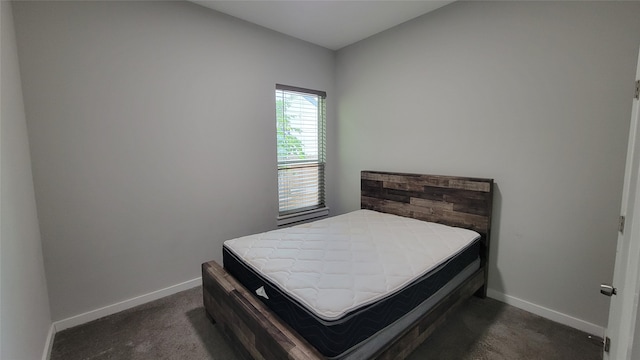 bedroom with dark colored carpet