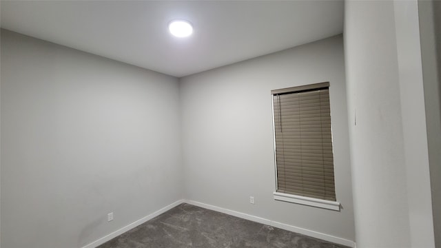 empty room with dark colored carpet